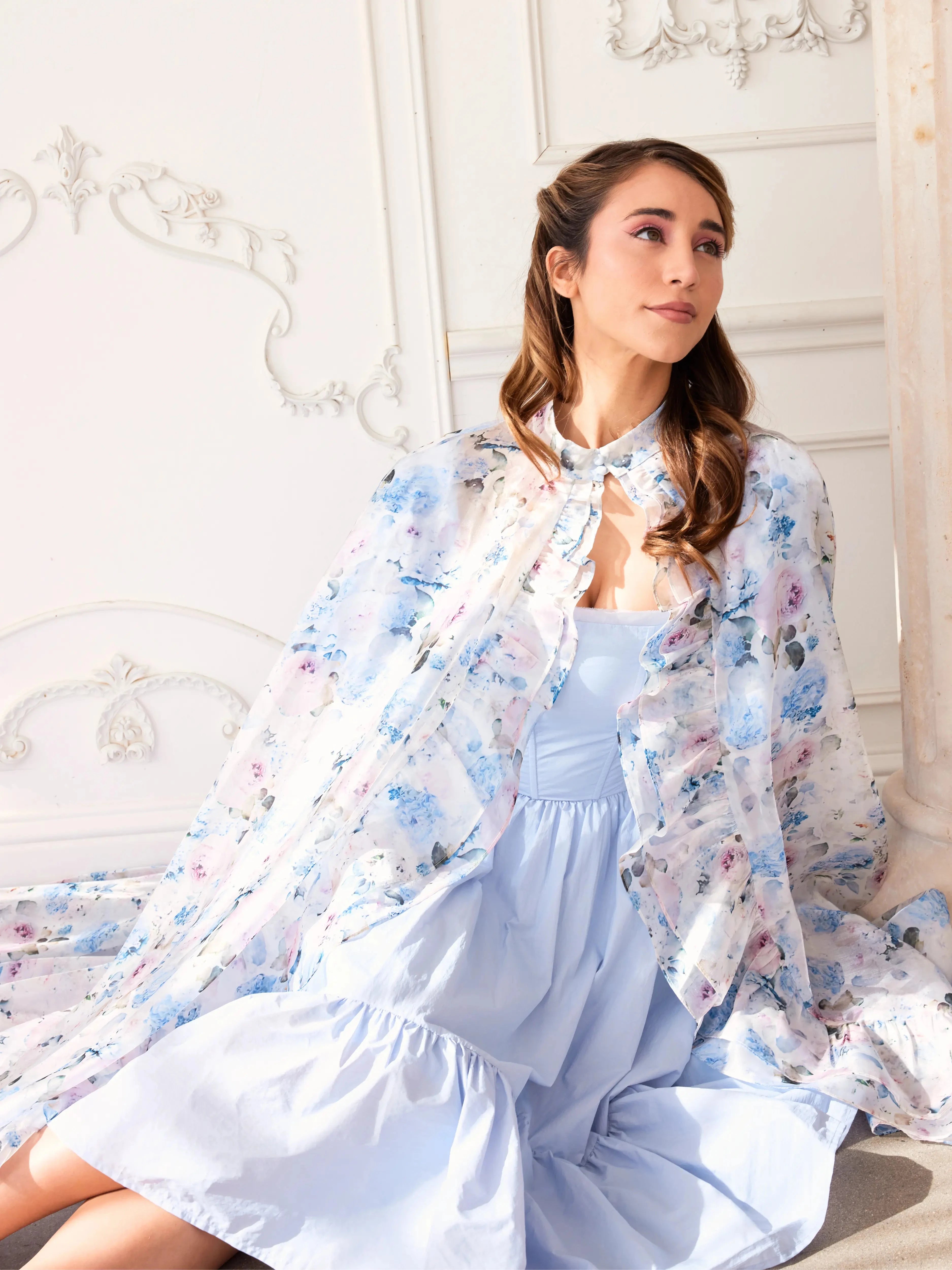 Alice Blue Josephine Midi Dress paired with a floral sheer cape, showcasing soft coquette fashion. Blue midi dress styled for romantic elegance.