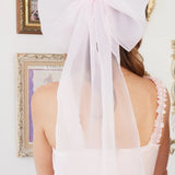 Ballerina Pink Grand Hair Bow in silk organza with 36-inch flowing tails, styled on long hair for a romantic, whimsical look.