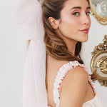 Side view of Ballerina Pink Grand Hair Bow in silk organza, adding a soft, elegant touch to a feminine hairstyle.