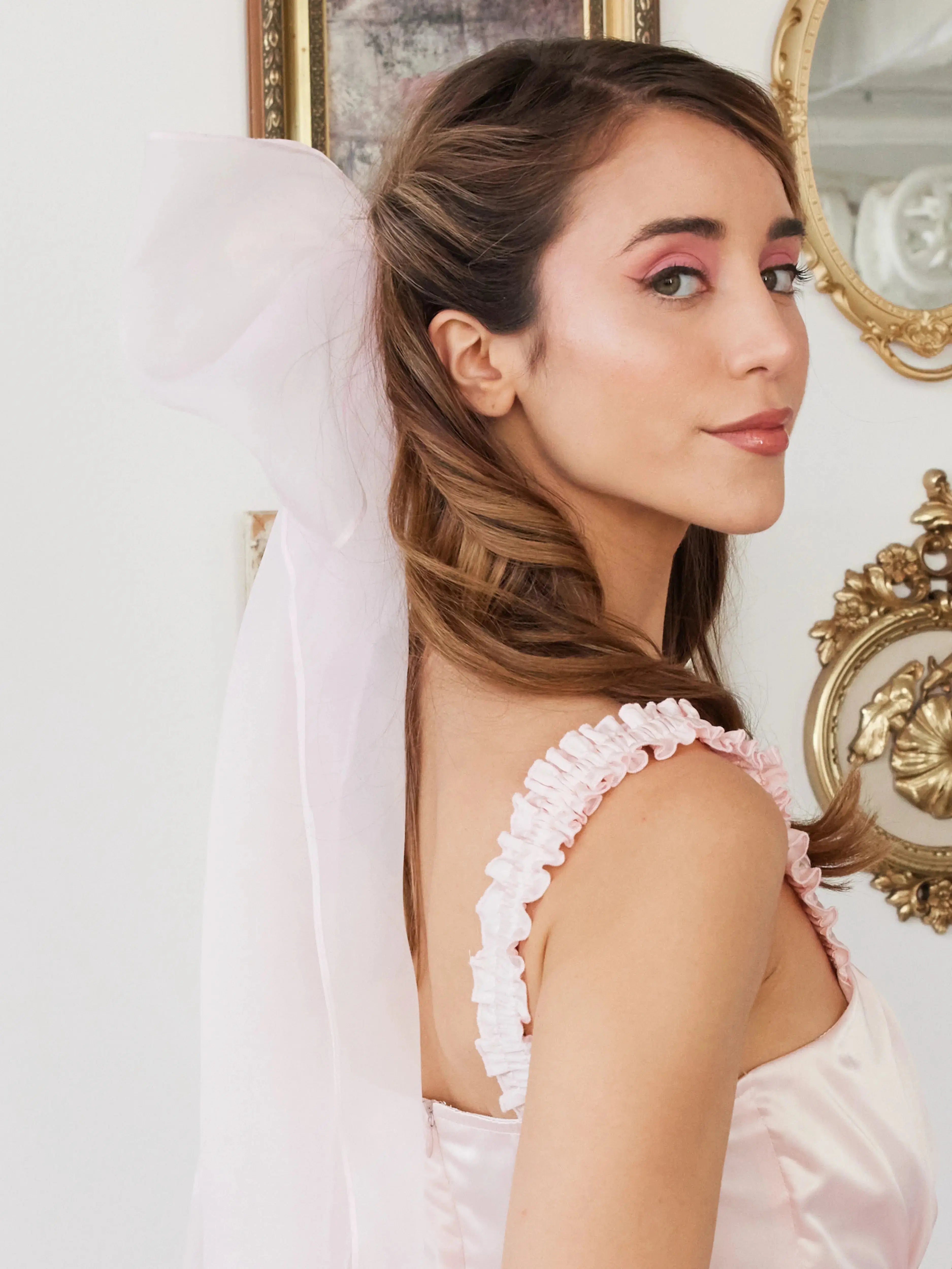 Side view of Ballerina Pink Grand Hair Bow in silk organza, adding a soft, elegant touch to a feminine hairstyle.