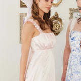 Model wearing Ballerina Pink Grand Hair Bow with a blush pink dress, showcasing its oversized, ethereal design.