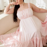 Ballerina Pink Satin Midi Dress with flowing silhouette and ruffle details, styled in a romantic lounge setting from the In-Bloom Collection N.3.