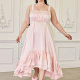 Ballerina Pink Satin Midi Dress with high-low ruffled hem and ruched bodice, modeled in a vintage room with matching pink bow heels.