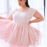 The Blossom Soft Pink Mini Dress is a pale pink tulle mini dress with lace overlay and empire waist.