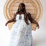 The Blue Toile Angel Dress styled in a boho setting with wicker chair.