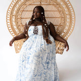 The Blue Toile Angel Dress styled in a boho setting with wicker chair.