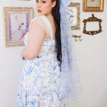 Oversized Blue Toile Grand Hair Bow with long flowing tails, paired with a matching toile print dress in a whimsical, feminine style.