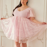 the Cherub Pink Lace Dress mini dress with angelic flutter sleeves and voluminous lace skirt, styled in a romantic vintage-inspired setting.