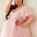 Close-up of the Cherub Pink Lace Dress showing delicate lace texture, soft flutter sleeves, and flattering sweetheart neckline.