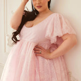 Close-up of the Cherub Pink Lace Dress showing delicate lace texture, soft flutter sleeves, and flattering sweetheart neckline.