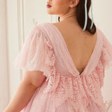 Back view of the Cherub Pink Lace Dress featuring intricate lace detailing and a low V-back design for a dreamy fairytale look.