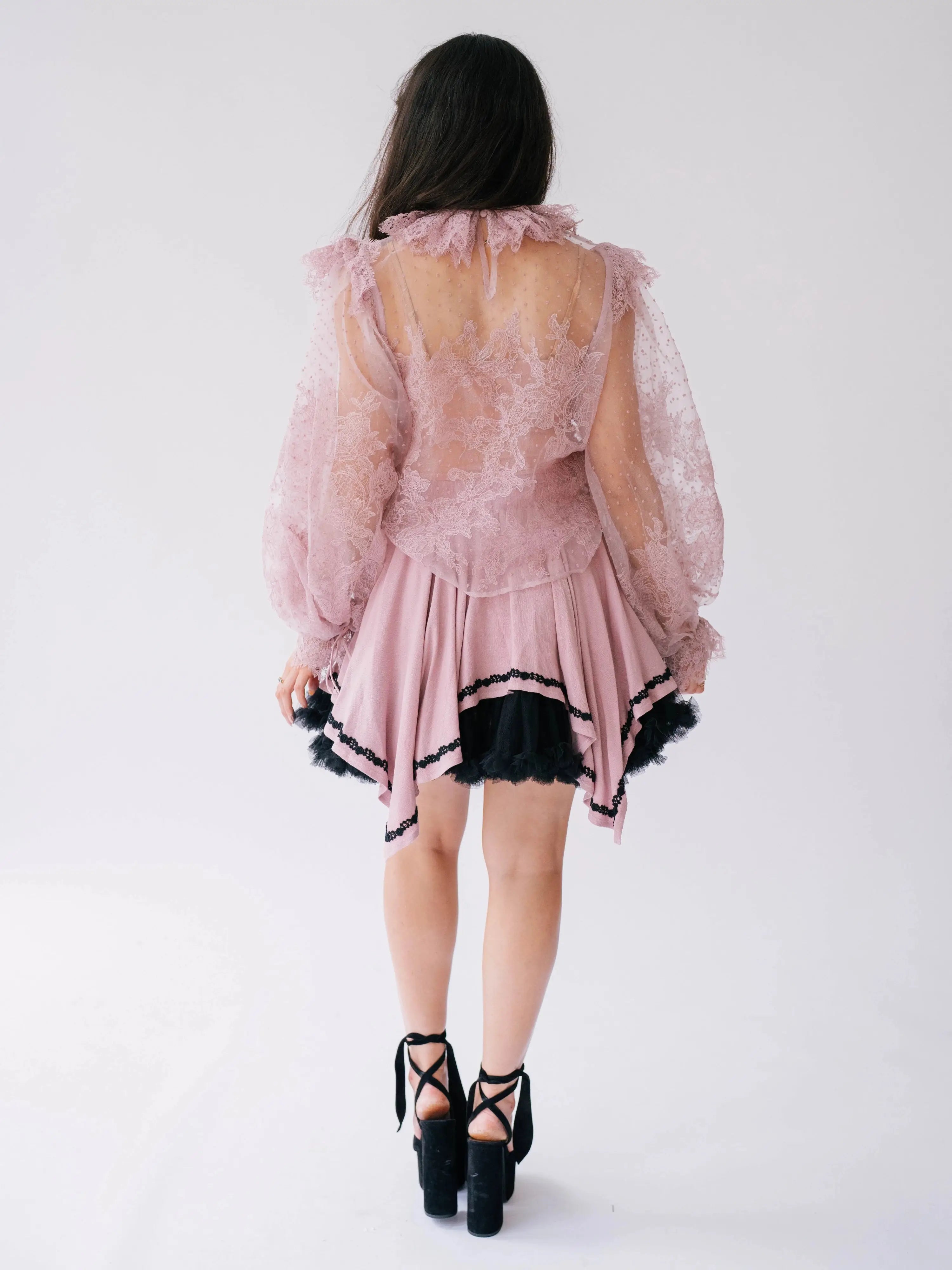 Back view of Eleanor Dusty Pink Lace Blouse showing sheer floral lace and ruffle neckline, perfect for elegant layering in romantic fashion.