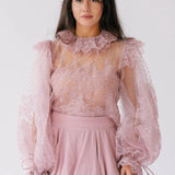 Front close-up of Eleanor Dusty Pink Lace Blouse showcasing sheer lace, puff sleeves, and ruffle collar, ideal for romantic and layered styling.