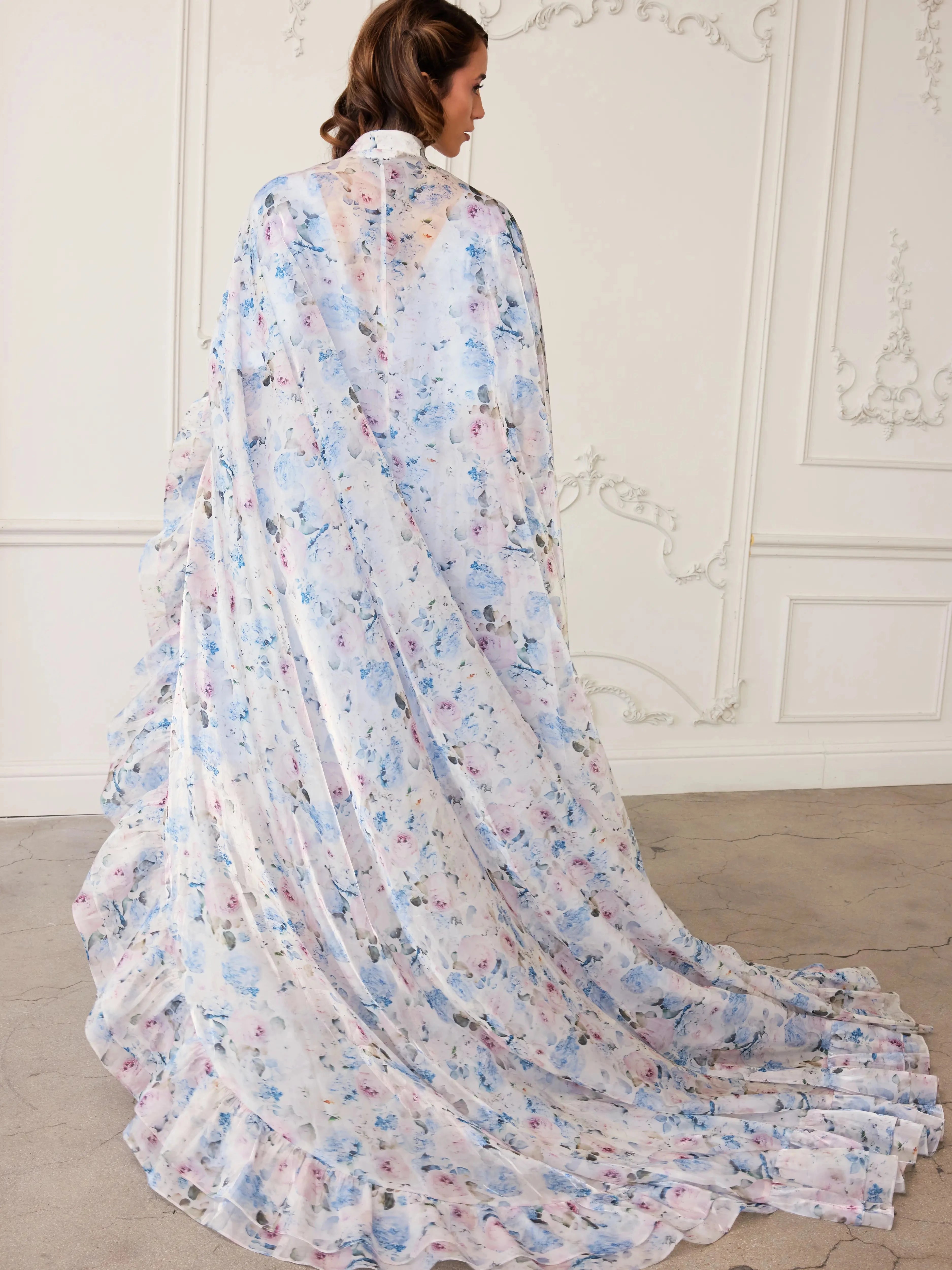 Back view of The High Priestess Renaissance Cloak showcasing a sweeping train and the soft floral wildbloom pattern, perfect for fantasy-inspired fashion.