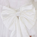 Close-up of the Ivory Bridal Grand Bow Belt showcasing intricate satin folds and secure clip detail for elegant bridal styling.