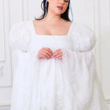 Plus-size model in Ivory Fairy Puff Sleeve Dress with embroidered tulle and square neckline, styled for inclusive women's mini dresses.