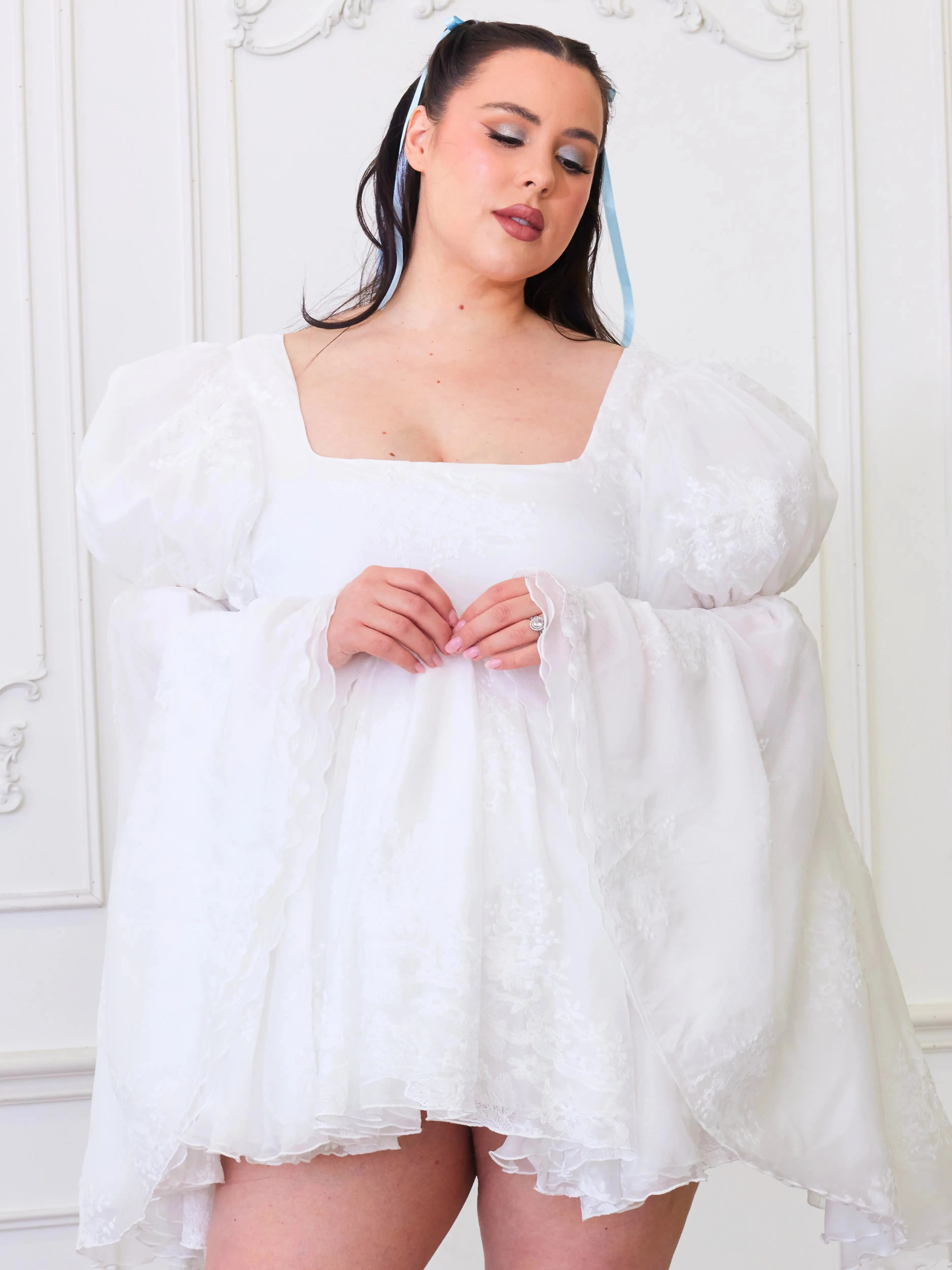 Plus-size model in Ivory Fairy Puff Sleeve Dress with embroidered tulle and square neckline, styled for inclusive women's mini dresses.