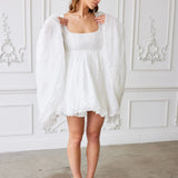 Ivory Fairy Puff Sleeve Dress shown with sleeves draped down, highlighting lace hem and soft tulle layers in women's dresses & gowns.