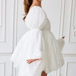 Side profile of Ivory Fairy Puff Sleeve Dress with flowing sleeves and embroidered tulle, styled for whimsical women's fashion.