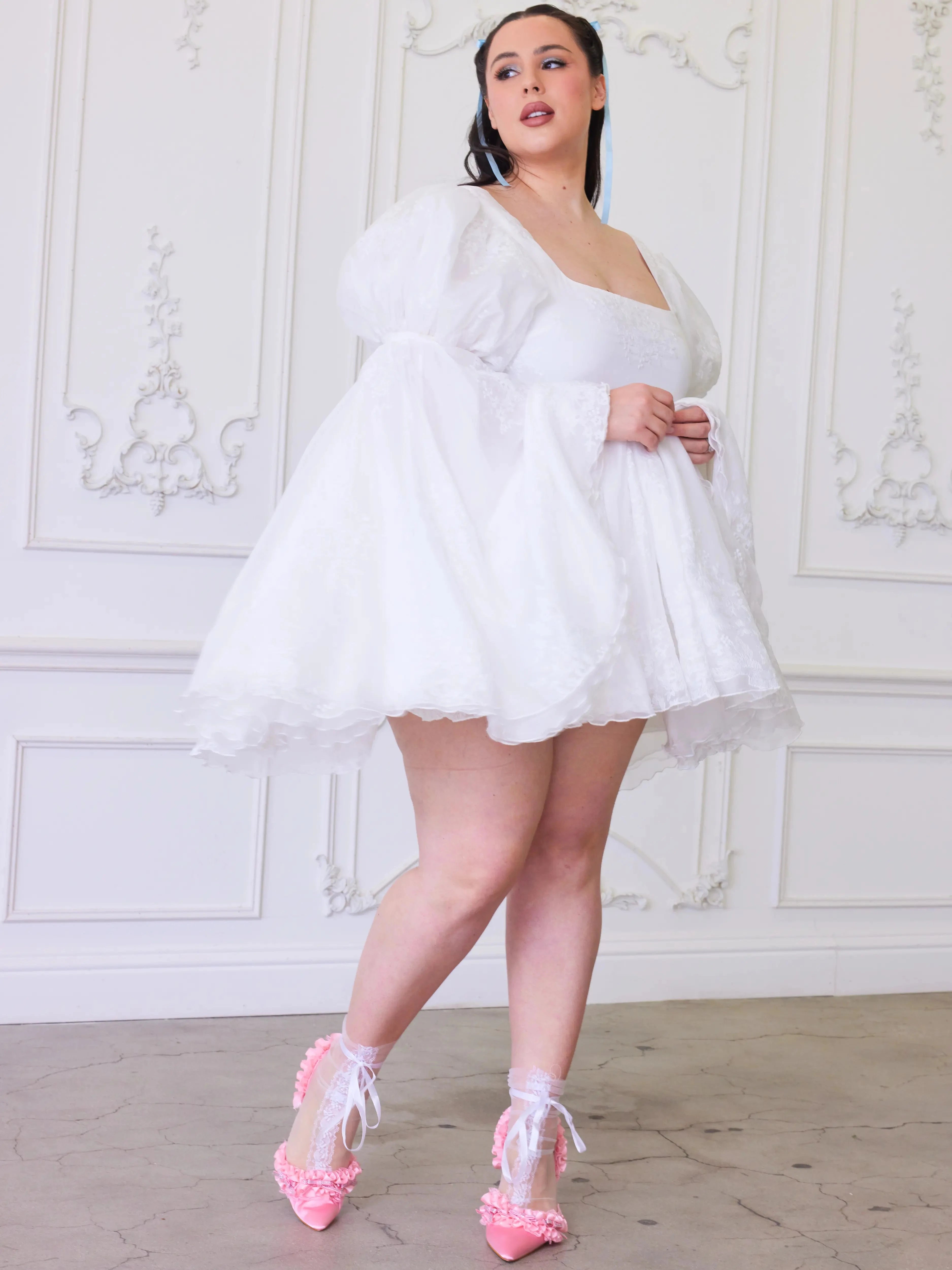 Ivory Fairy Puff Sleeve Dress styled with pink heels and lace socks, showcasing flared skirt and puff sleeves for women's fashion.