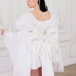 Back view of Ivory Fairy Puff Sleeve Dress with oversized satin bow and flared tulle skirt, perfect for elegant women's mini dresses.