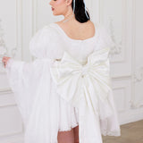 Back view of Ivory Fairy Puff Sleeve Dress with oversized satin bow and flared tulle skirt, perfect for elegant women's mini dresses.