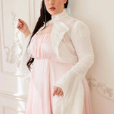Model poses in the Ivory Lady Elizabeth Bolero Jacket, featuring floral lace design, ruffled collar, and soft bell sleeves in a vintage setting.