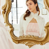 Ivory Lady Elizabeth Bolero Jacket reflected in ornate mirror, highlighting its romantic high collar and vintage-inspired silhouette.