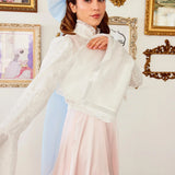 Back view of the Ivory Lady Elizabeth Bolero Jacket with flowing bell sleeves and embroidered lace, styled with a pastel pink dress.