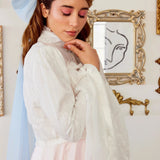 Side view of the Ivory Lady Elizabeth Bolero Jacket showcasing sheer lace fabric, romantic bell sleeves, and elegant high neck design.