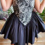 Strapless Rhiannon Corset Dress featuring patterned corset bodice and a black skirt with tulle underneath for a puff effect.