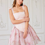 The Rosewater Corset Mini Dress, a Victorian Corset Dress featuring structured bodice and floral skirt, modeled in elegant white interior.