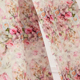 Close-up of the Rosewater Grand Bow Belt's custom floral satin fabric, showcasing intricate rose print in soft pink and green hues.