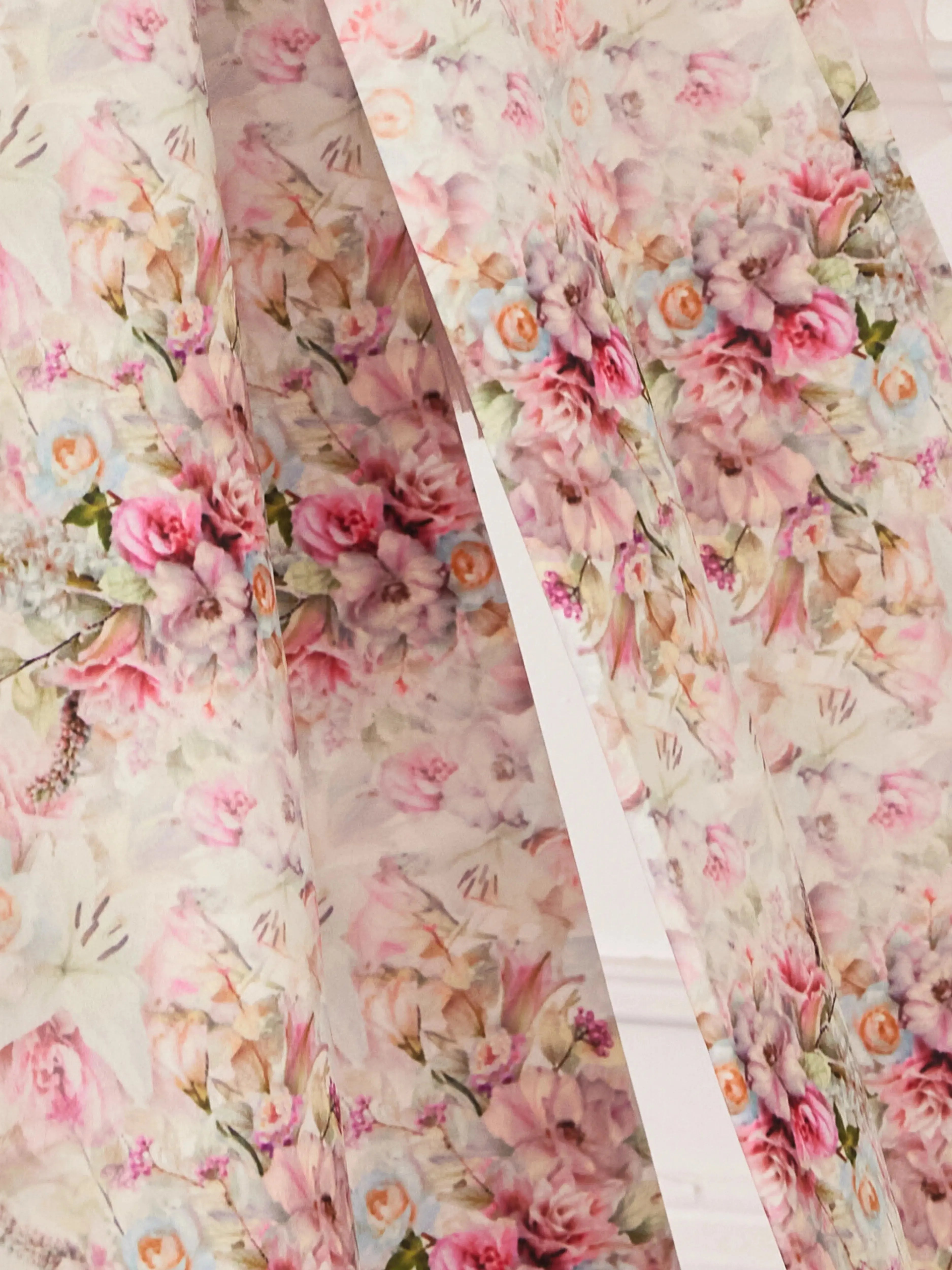 Close-up of the Rosewater Grand Bow Belt's custom floral satin fabric, showcasing intricate rose print in soft pink and green hues.