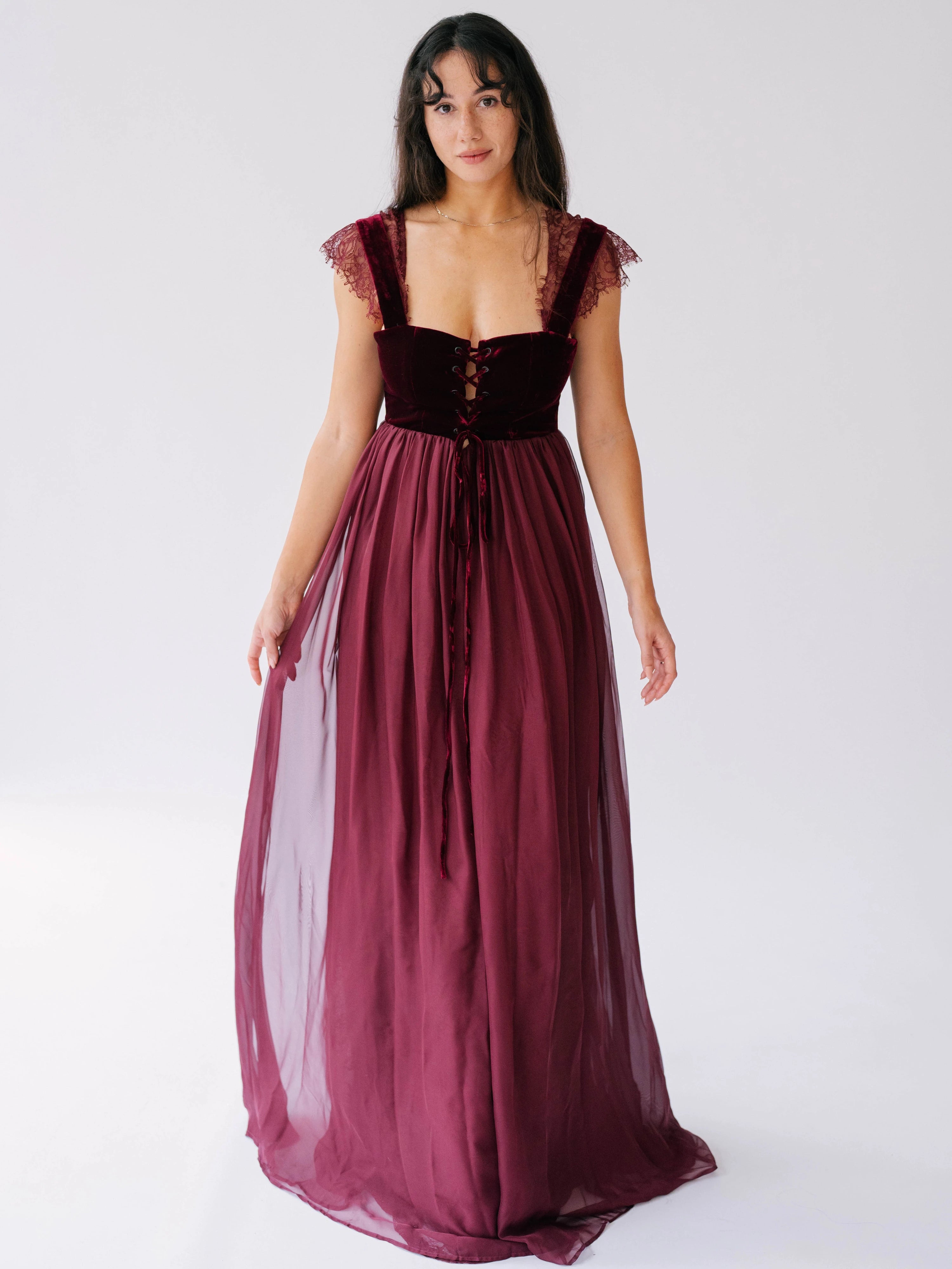 A Scarlet red floor length gown, with lace trim straps and velvet corset bodice.