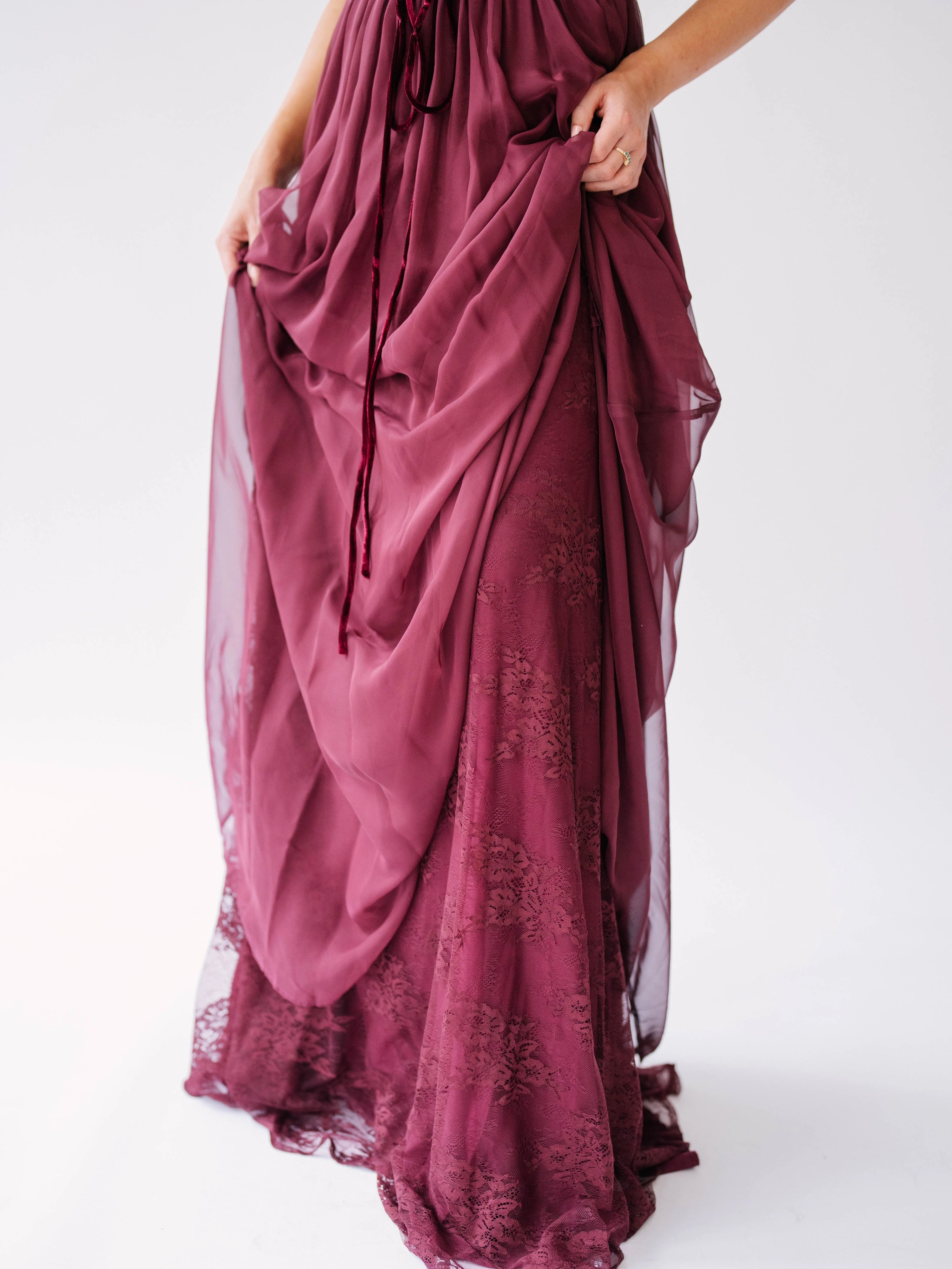 Flowing scarlet red maxi dress with delicate floral embroidery and gathered chiffon fabric details.