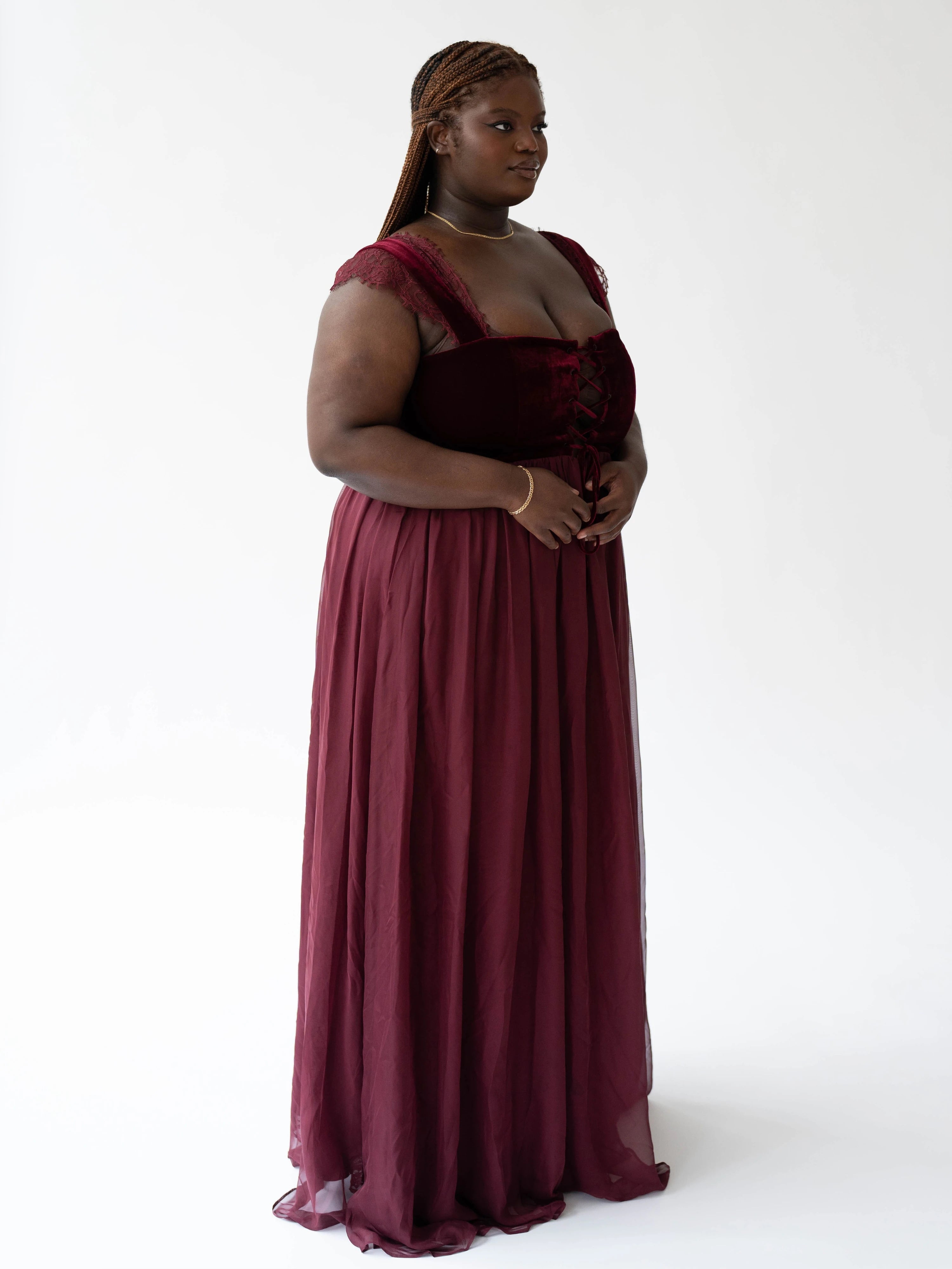 The Scarlet Red Scorned Lovers Gown is a corset maxi dress with a square neckline and multilayered skirt with floral embroidery on the inner layers.