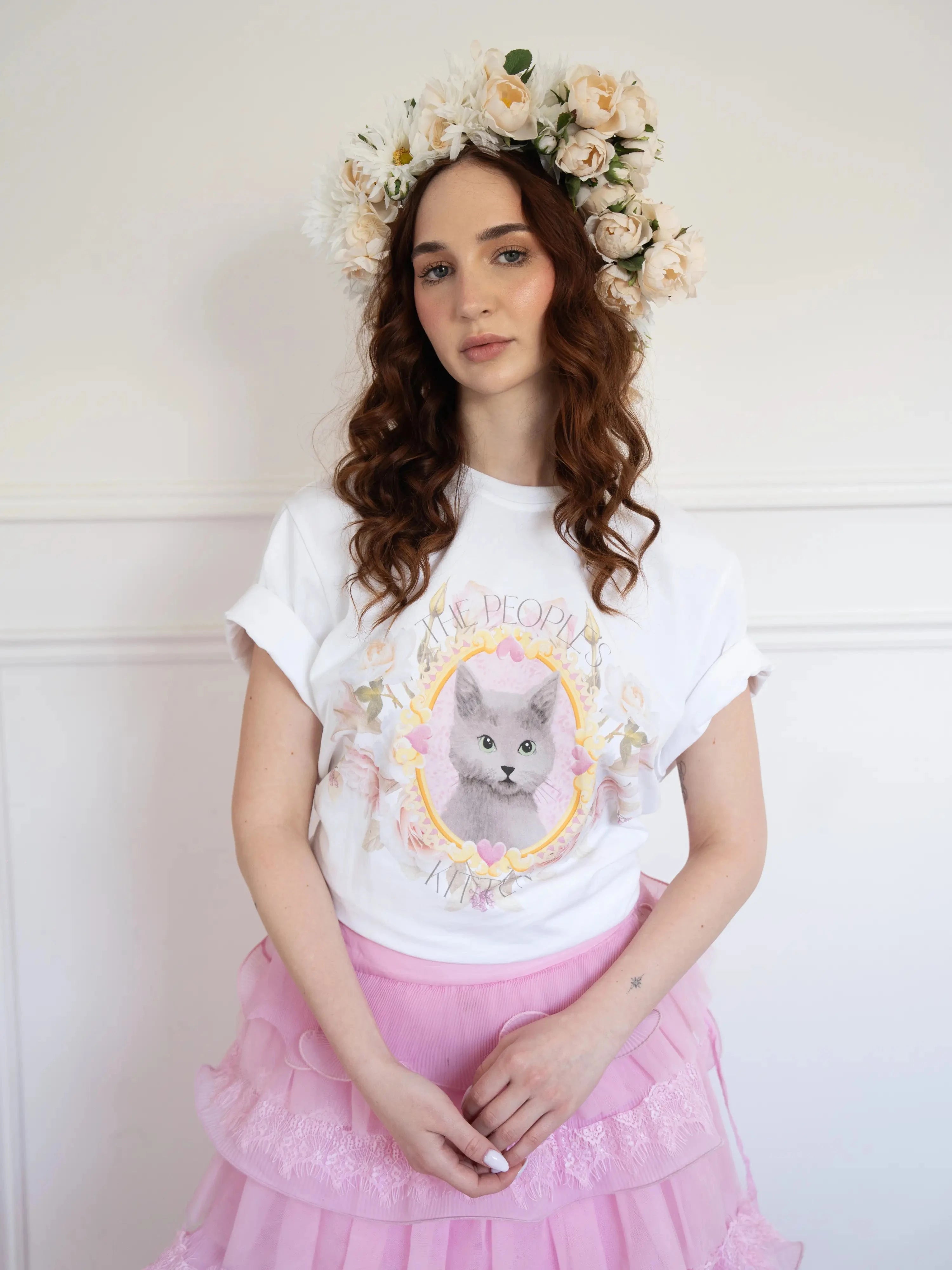 The Princess Kitten Tee worn with a pink ruffled skirt and floral crown, showcasing the regal kitten design in a soft, feminine outfit.