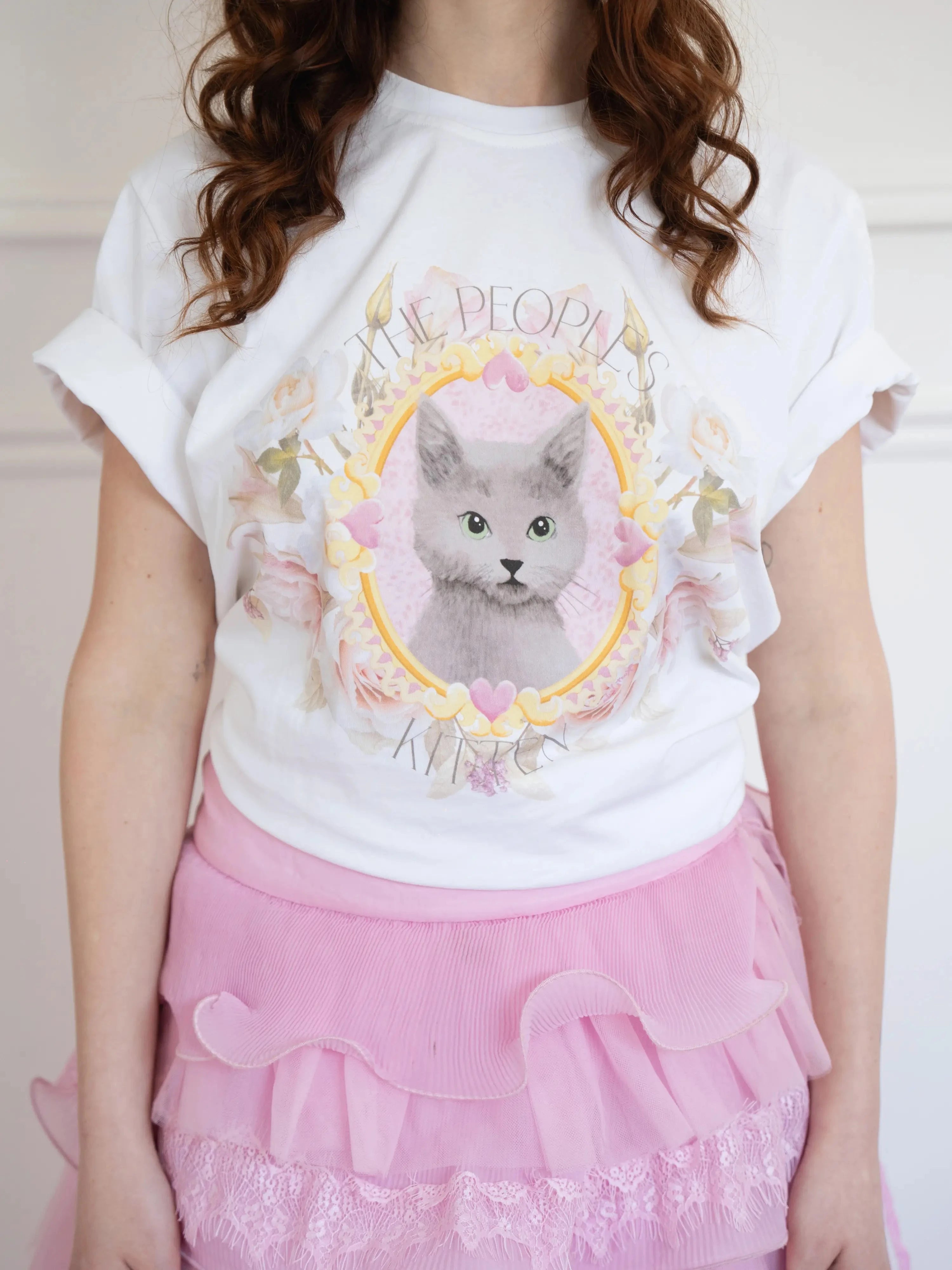 Front view of The Princess Kitten Tee paired with a pink layered skirt, emphasizing the dreamy feline artwork and soft cotton texture.