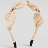 The Adorned Pearl Headband in ivory satin with pearl and crystal embellishments, perfect for elegant, timeless hair styling. Ideal for formal or bridal looks.
