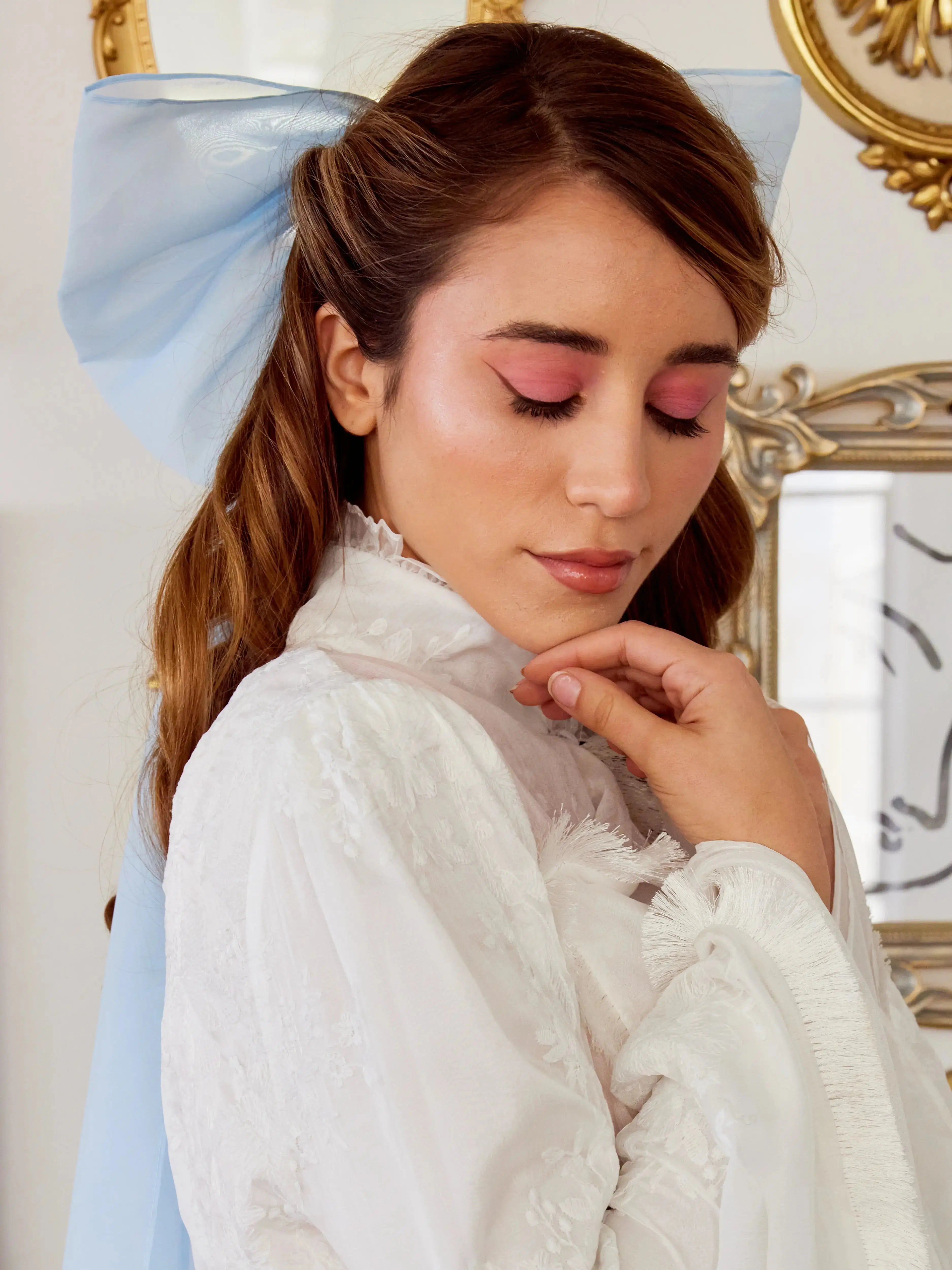 Close-up of Caylee wearing the Alice Blue Grand Hair Bow showcasing its voluminous silk organza design.