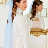 Caylee wearing the Alice Blue Grand Hair Bow featuring dreamy 36-inch tails, styled with a high-neck embroidered blouse for an ethereal aesthetic.