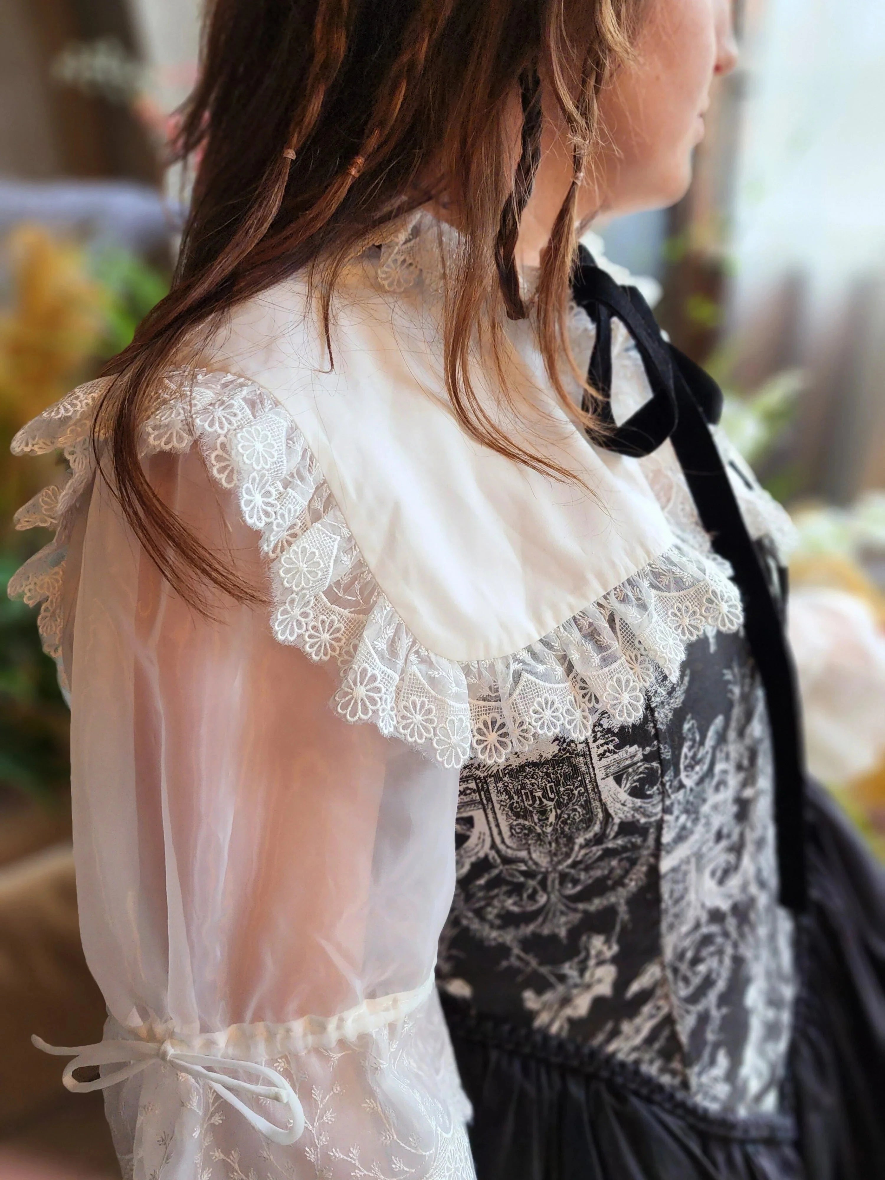 Close-up view of the ciela snow white shrug top's organza sleeves.