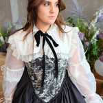 Front view of a woman wearing a Victorian-style corset dress underneath the Ciela Snow White Shrug.