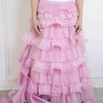 Front view of the dahlia pink ruffle skirt, intricate lace, and ruffle details.