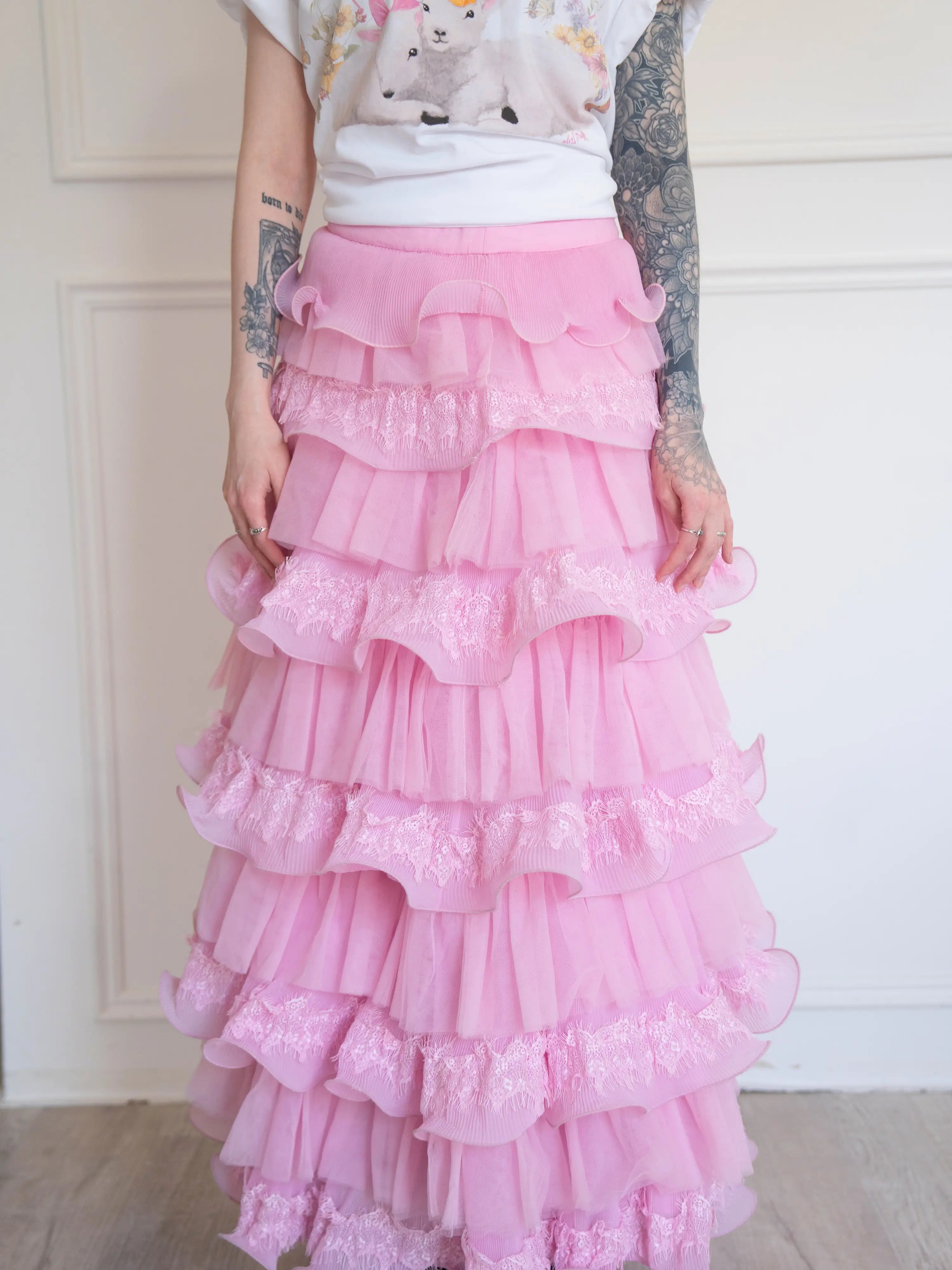 The Dahlia Ruffle Skirt | Fantasy Skirts detailed view of pink ruffles and lace tiers, styled with a whimsical printed tee for a playful look.