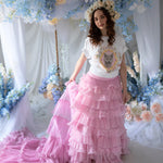 The Dahlia Ruffle Skirt | Fantasy Skirts with hand-crimped ruffles and lace accents, styled in a whimsical floral backdrop for a fairy-tale look.