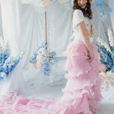 The Dahlia Ruffle Skirt | Fantasy Skirts featuring cascading pink ruffles and a dramatic train, styled with a floral crown in a dreamy setup.