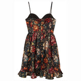 Floral stained glass print on a satin mini dress with black straps against a white background.