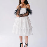 Full-body view of The Eleanor Black Feather Gloves styled with a white layered dress and black heels.